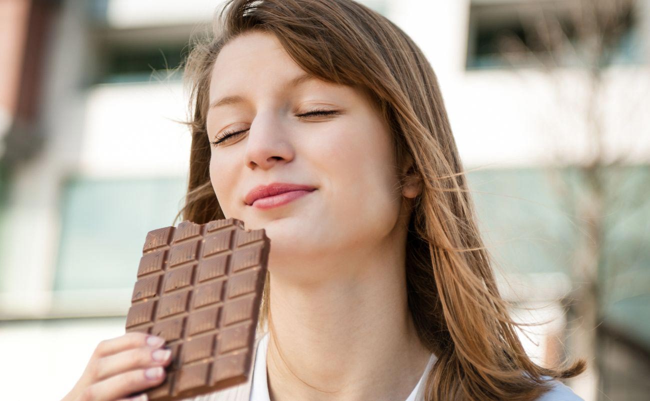 on Valentines Day Women eating chocolate and thinking of Someone